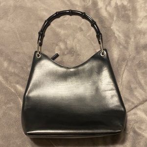 All black Gucci Bag with a bamboo handle